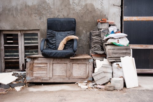 Cluttered flat being organized for clearance in Redbridge